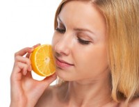 Portrait of teenage girl holding lemon