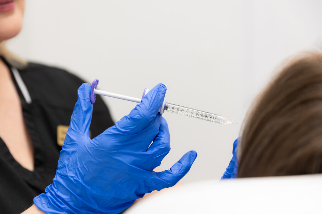 A Hermann injector administers a patient's under-eye filler in St. Petersburg.